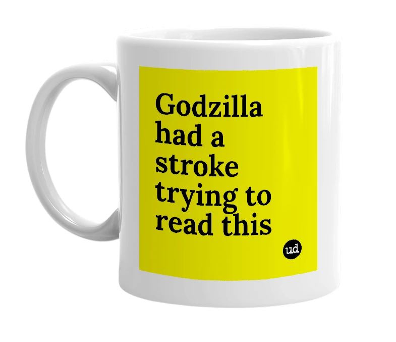White mug with 'Godzilla had a stroke trying to read this' in bold black letters