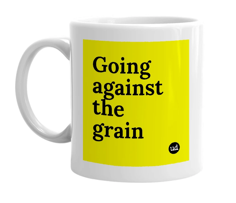 White mug with 'Going against the grain' in bold black letters