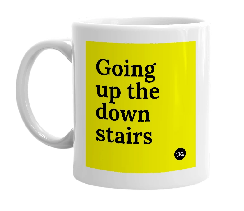 White mug with 'Going up the down stairs' in bold black letters
