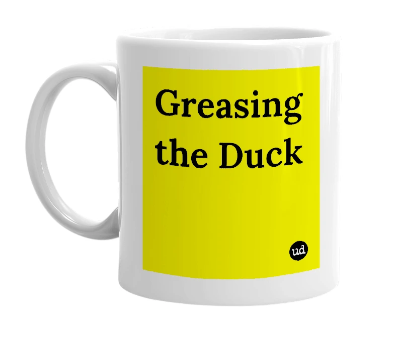 White mug with 'Greasing the Duck' in bold black letters