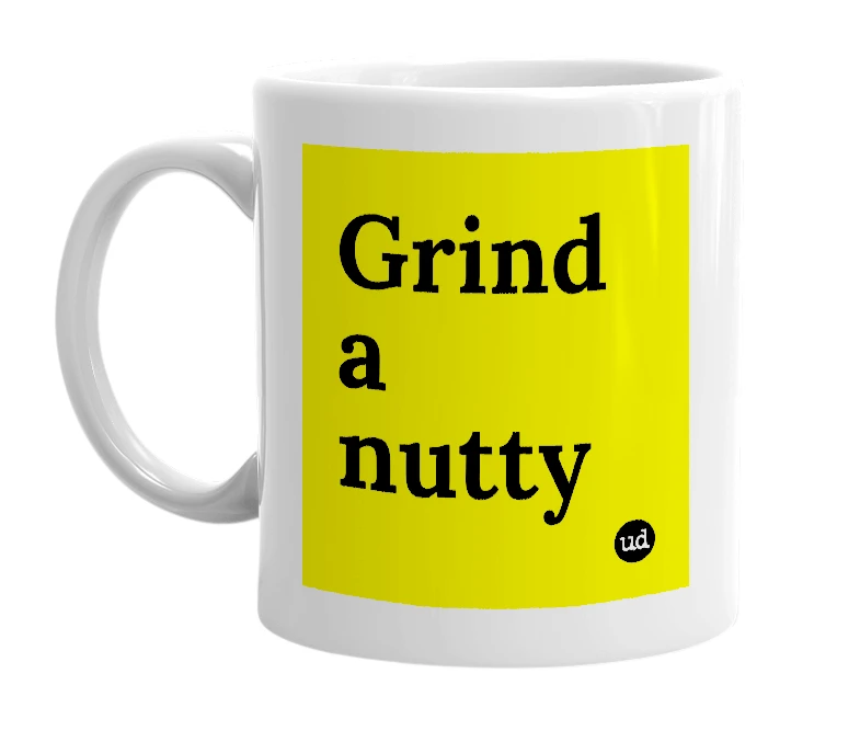 White mug with 'Grind a nutty' in bold black letters