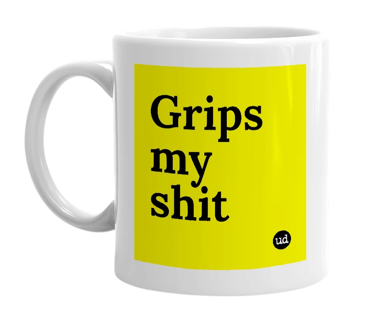 White mug with 'Grips my shit' in bold black letters