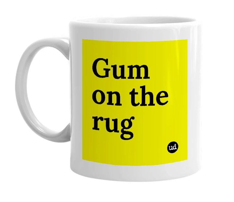 White mug with 'Gum on the rug' in bold black letters