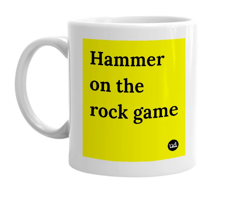 White mug with 'Hammer on the rock game' in bold black letters
