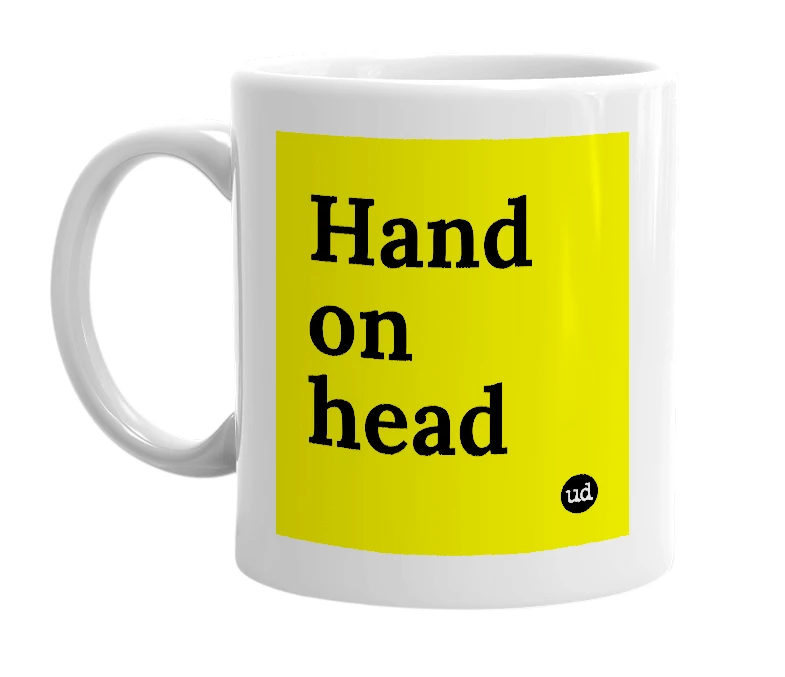 White mug with 'Hand on head' in bold black letters