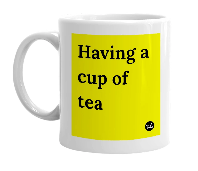 White mug with 'Having a cup of tea' in bold black letters