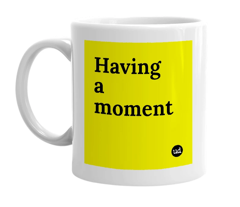 White mug with 'Having a moment' in bold black letters