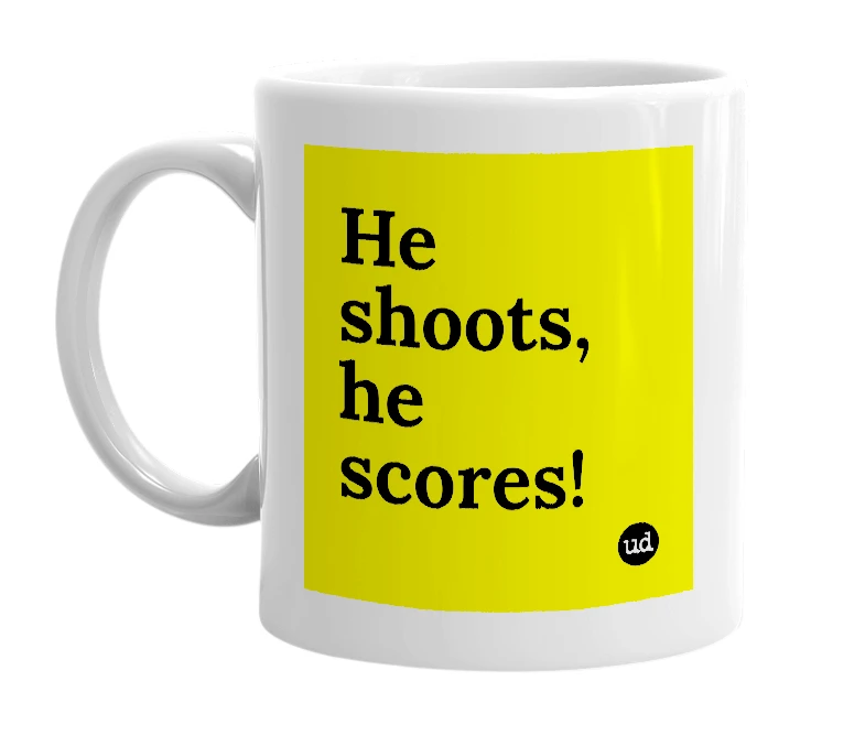 White mug with 'He shoots, he scores!' in bold black letters