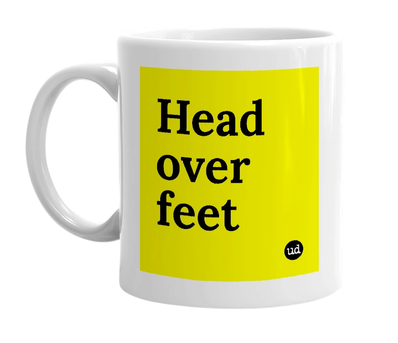 White mug with 'Head over feet' in bold black letters