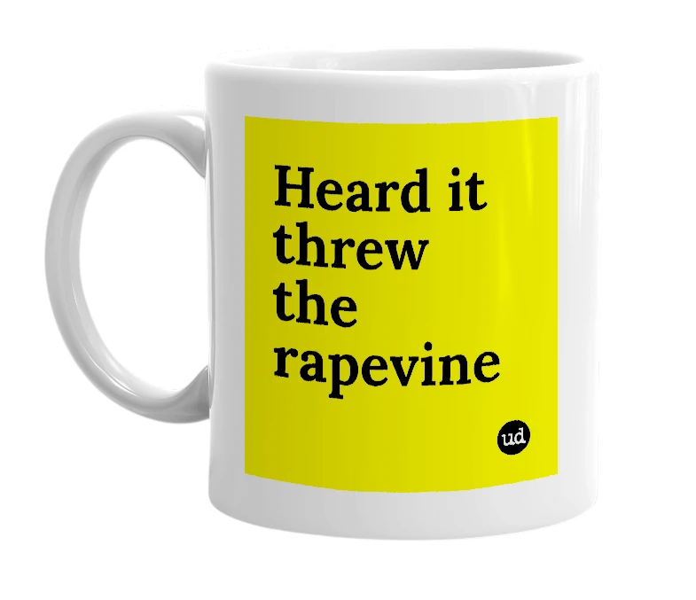 White mug with 'Heard it threw the rapevine' in bold black letters