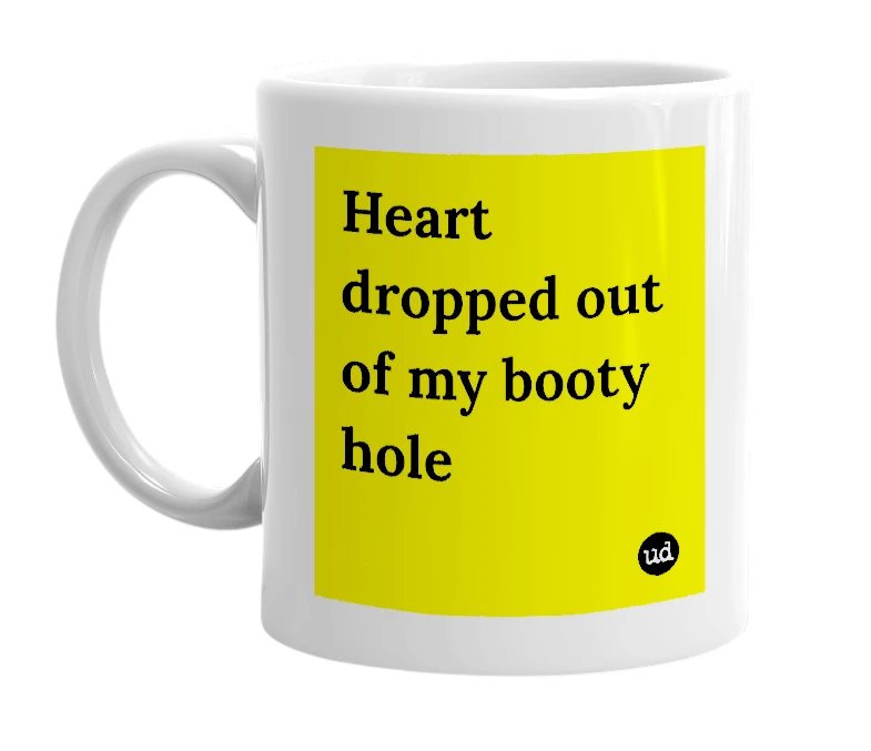 White mug with 'Heart dropped out of my booty hole' in bold black letters