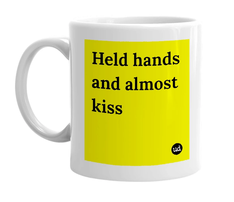 White mug with 'Held hands and almost kiss' in bold black letters