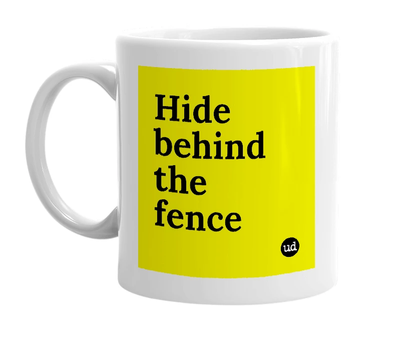 White mug with 'Hide behind the fence' in bold black letters