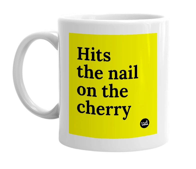 White mug with 'Hits the nail on the cherry' in bold black letters