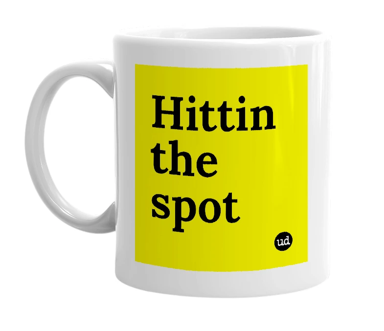 White mug with 'Hittin the spot' in bold black letters