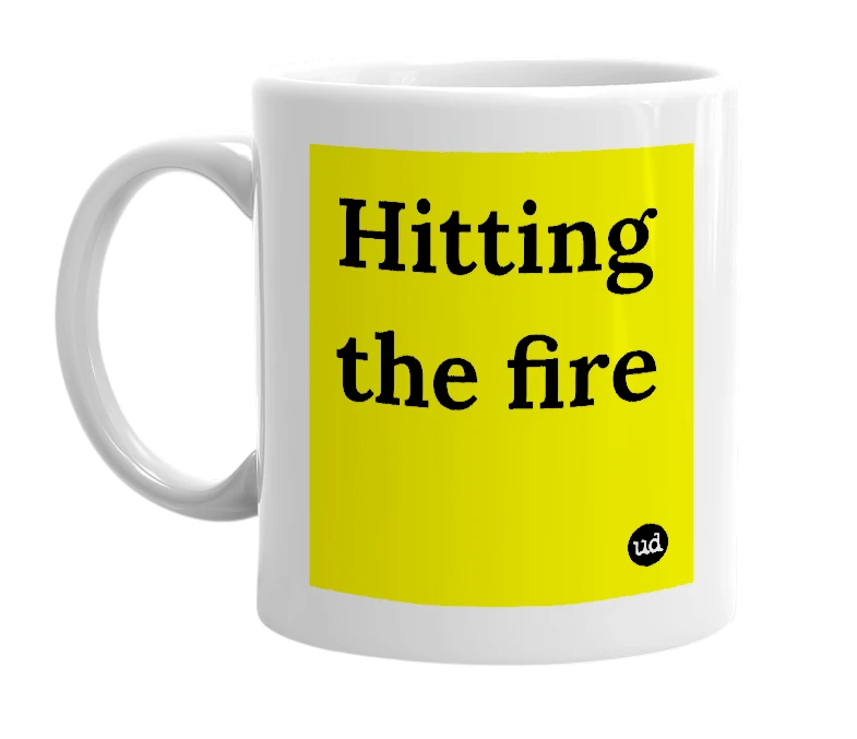White mug with 'Hitting the fire' in bold black letters