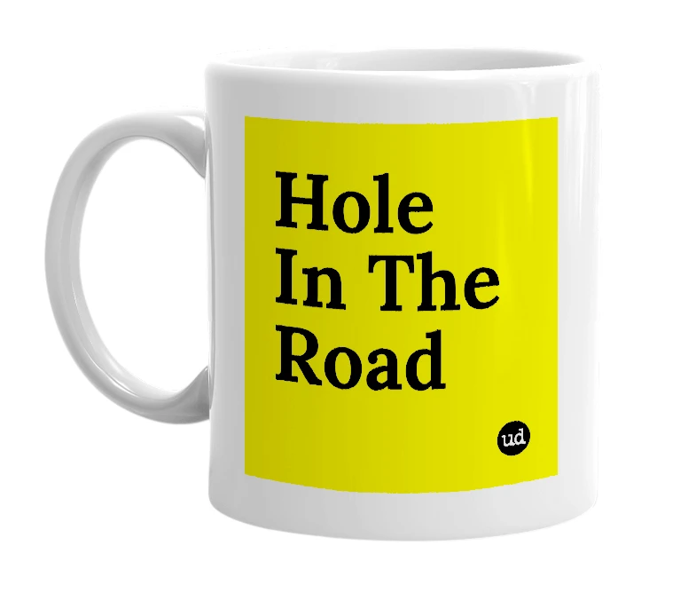 White mug with 'Hole In The Road' in bold black letters