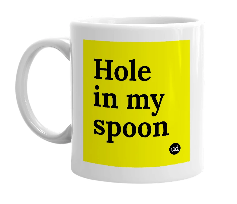 White mug with 'Hole in my spoon' in bold black letters