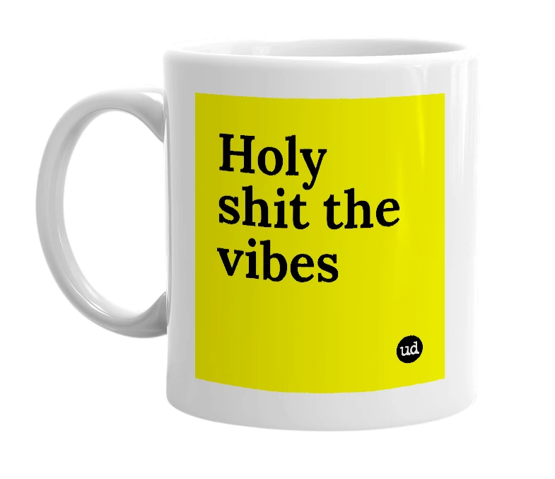 White mug with 'Holy shit the vibes' in bold black letters