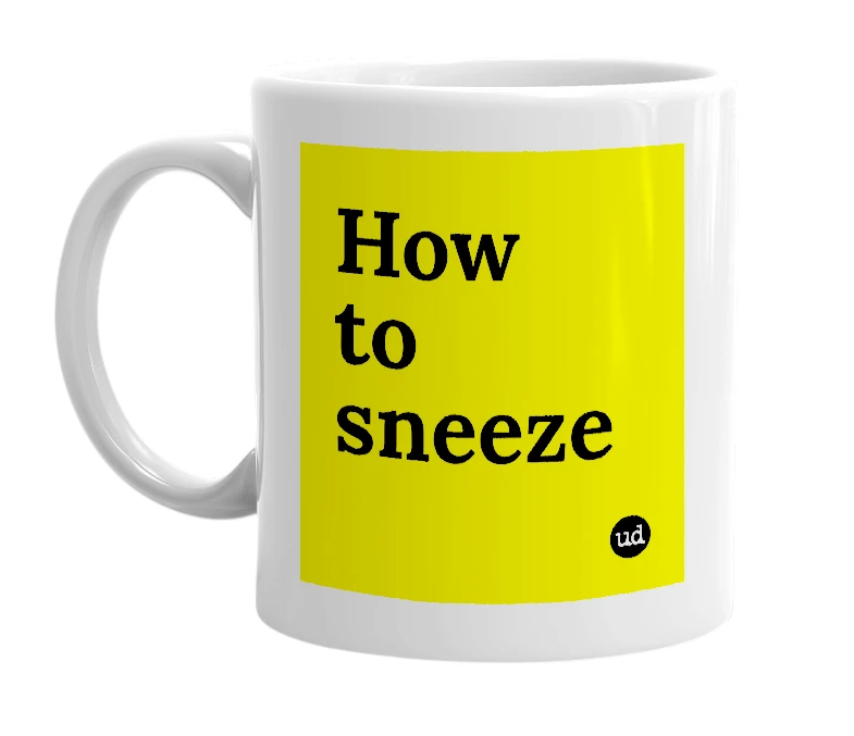 White mug with 'How to sneeze' in bold black letters