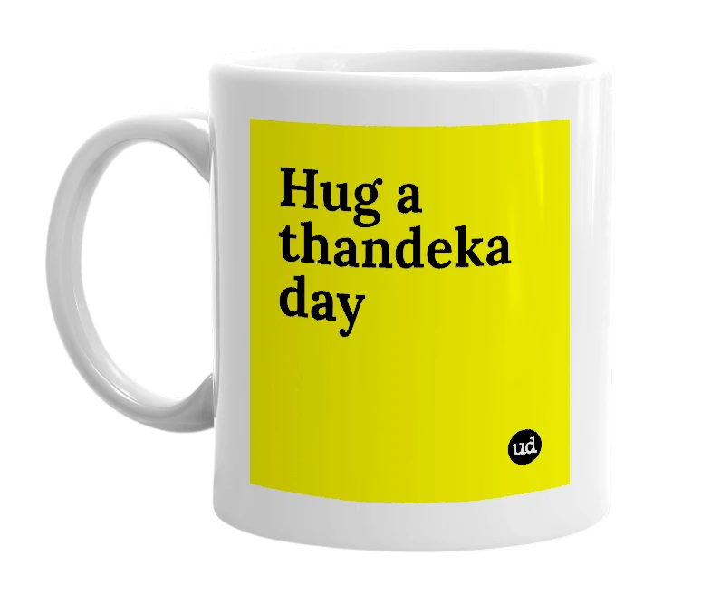 White mug with 'Hug a thandeka day' in bold black letters