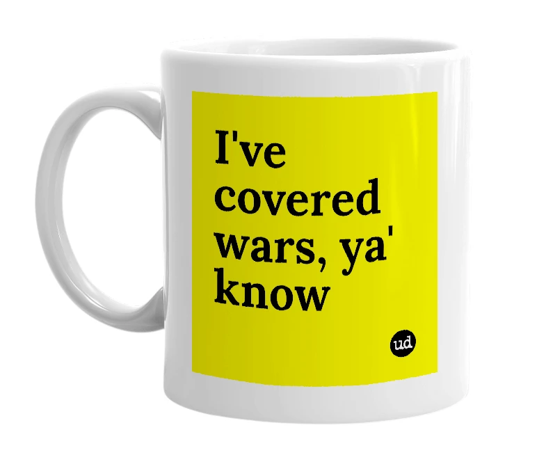 White mug with 'I've covered wars, ya' know' in bold black letters