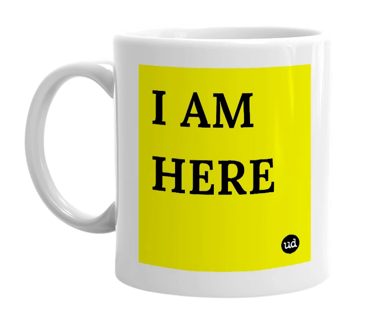 White mug with 'I AM HERE' in bold black letters