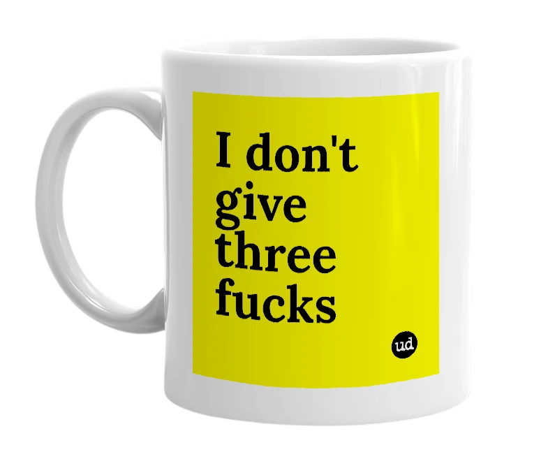 White mug with 'I don't give three fucks' in bold black letters