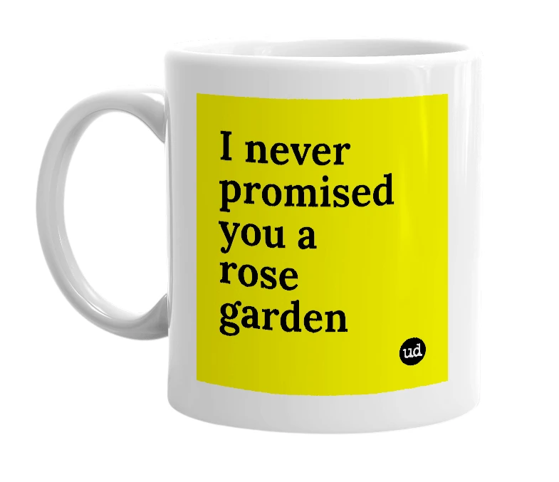 White mug with 'I never promised you a rose garden' in bold black letters