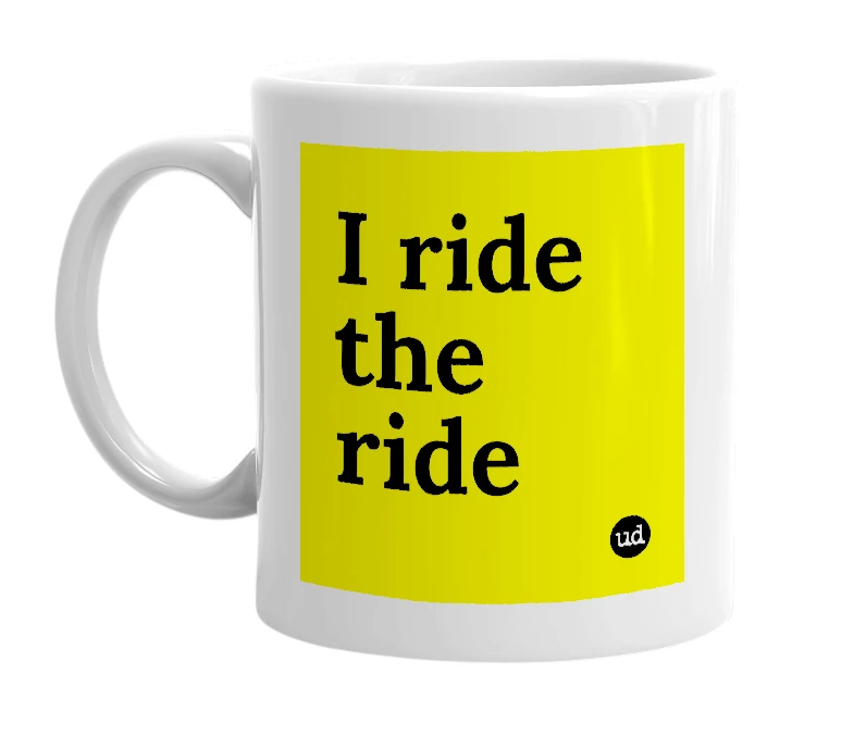 White mug with 'I ride the ride' in bold black letters