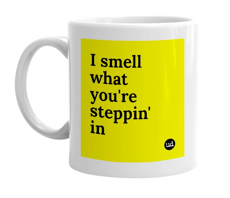 White mug with 'I smell what you're steppin' in' in bold black letters