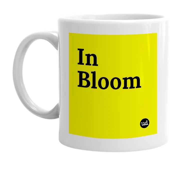 White mug with 'In Bloom' in bold black letters