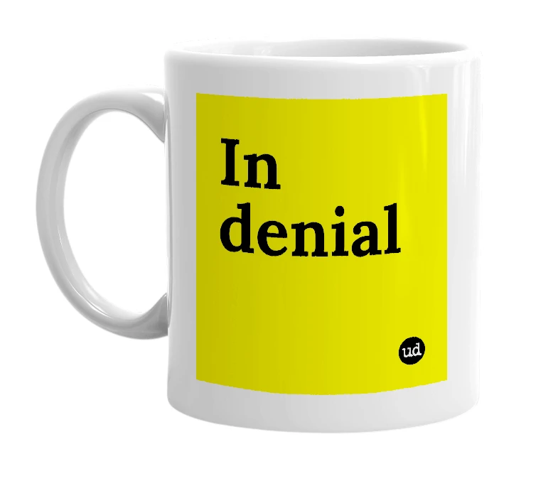 White mug with 'In denial' in bold black letters