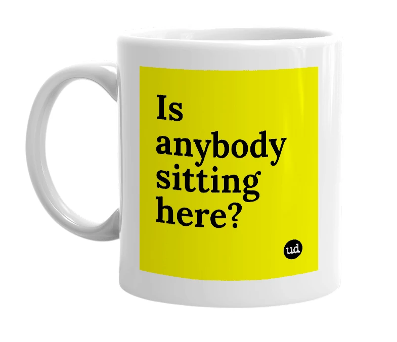 White mug with 'Is anybody sitting here?' in bold black letters