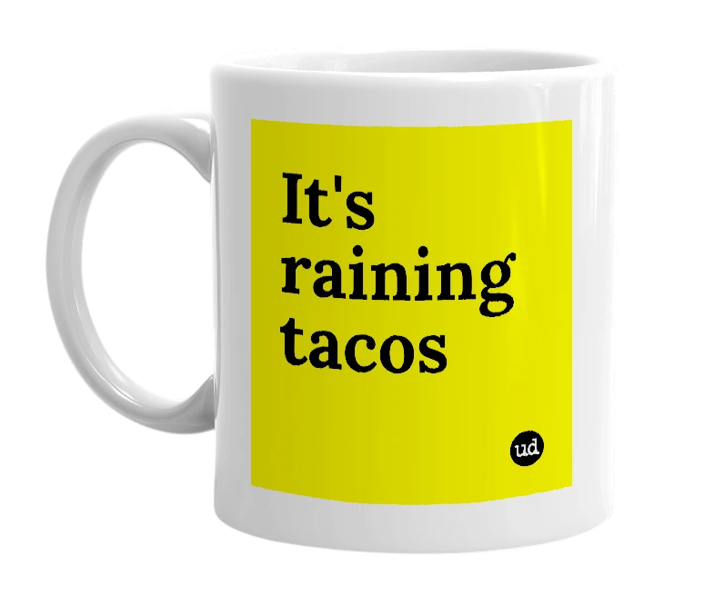White mug with 'It's raining tacos' in bold black letters