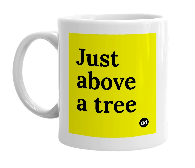 White mug with 'Just above a tree' in bold black letters