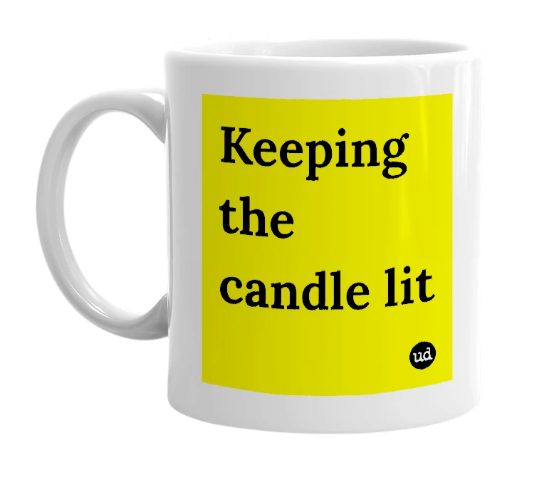 White mug with 'Keeping the candle lit' in bold black letters