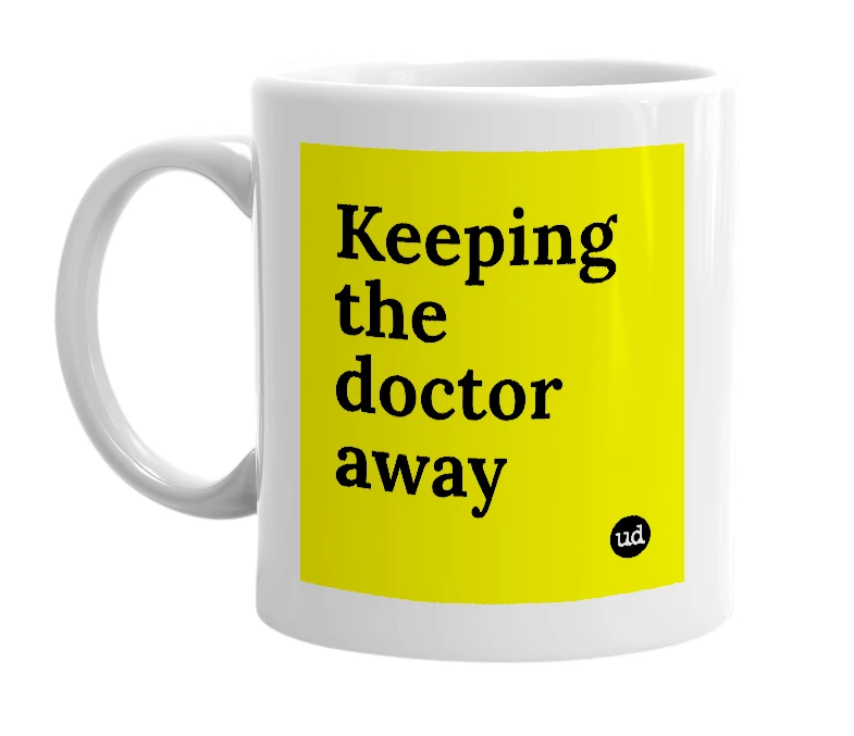 White mug with 'Keeping the doctor away' in bold black letters