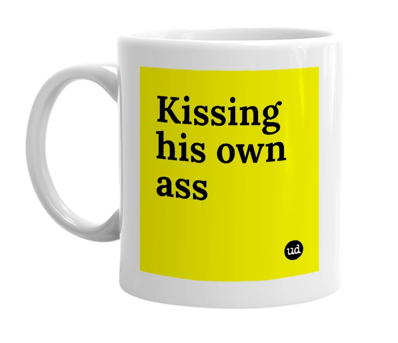 White mug with 'Kissing his own ass' in bold black letters