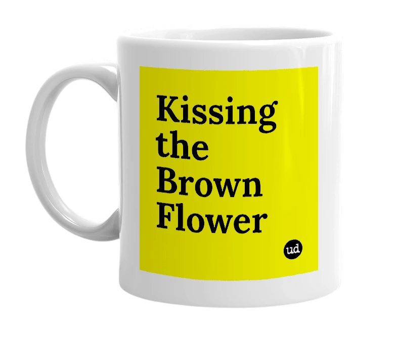 White mug with 'Kissing the Brown Flower' in bold black letters