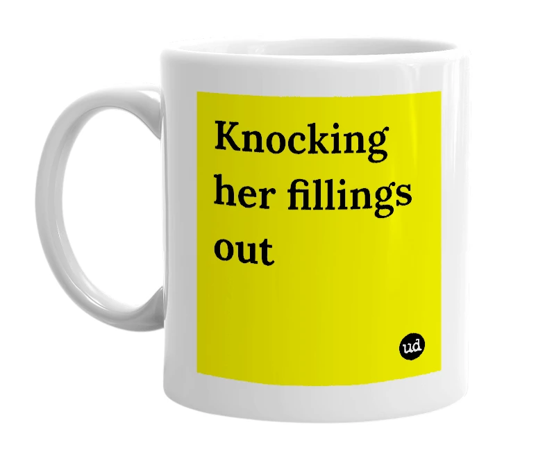 White mug with 'Knocking her fillings out' in bold black letters