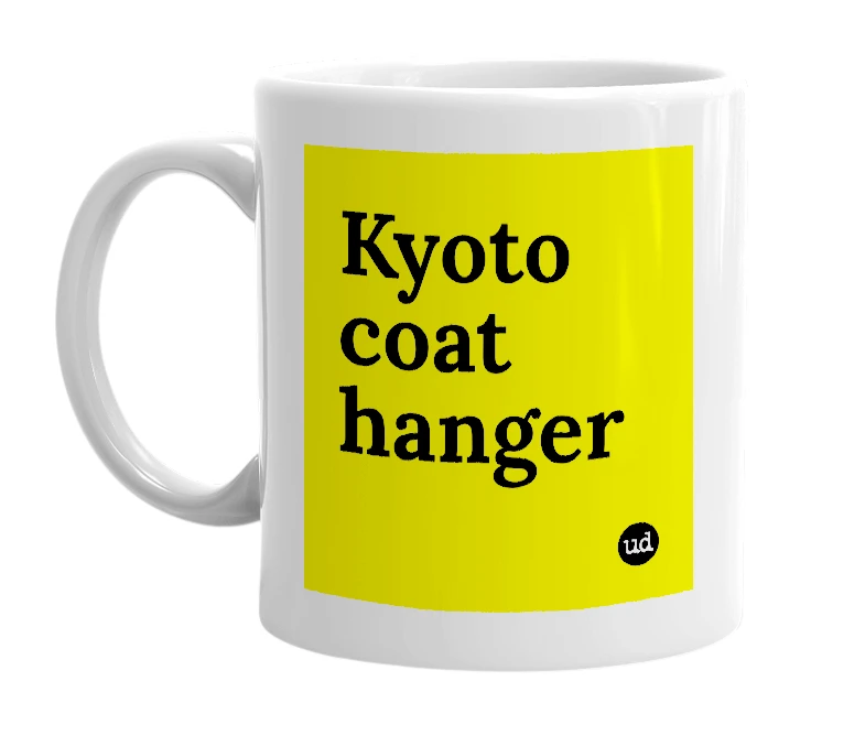 White mug with 'Kyoto coat hanger' in bold black letters