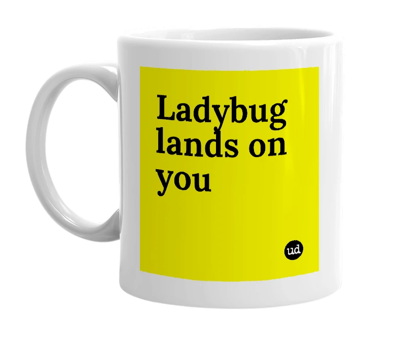 White mug with 'Ladybug lands on you' in bold black letters