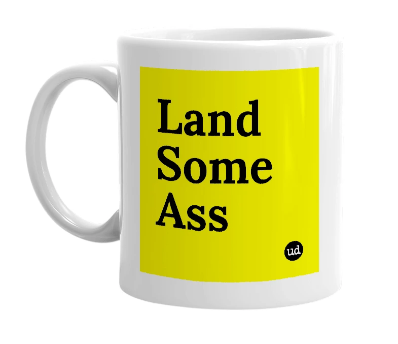 White mug with 'Land Some Ass' in bold black letters