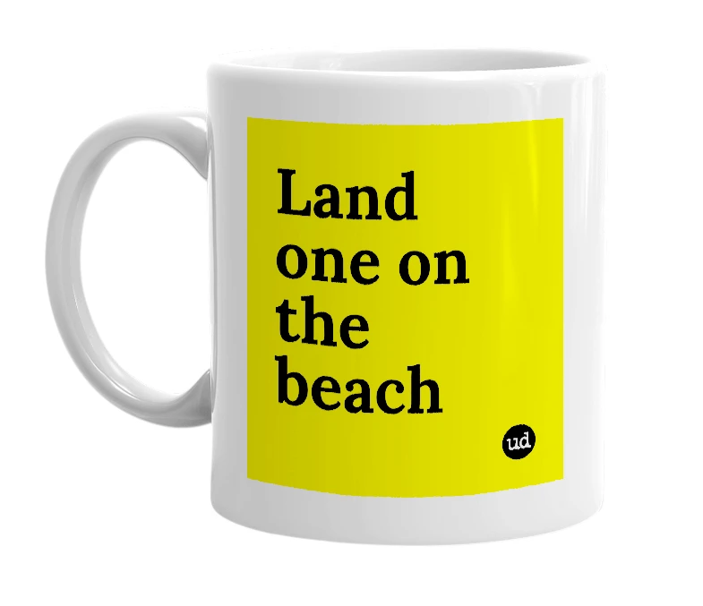 White mug with 'Land one on the beach' in bold black letters