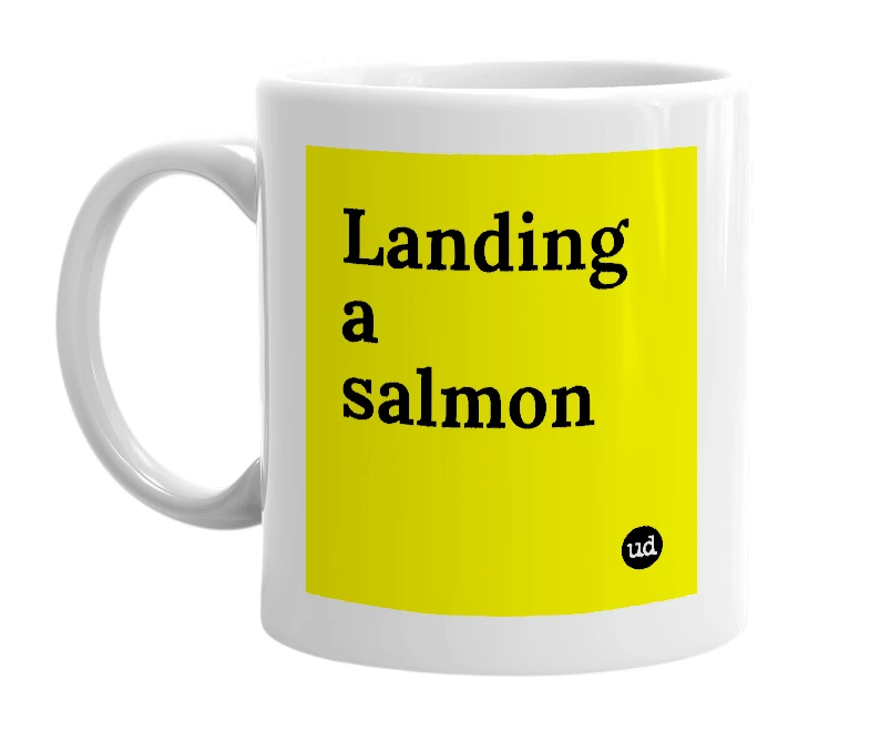 White mug with 'Landing a salmon' in bold black letters