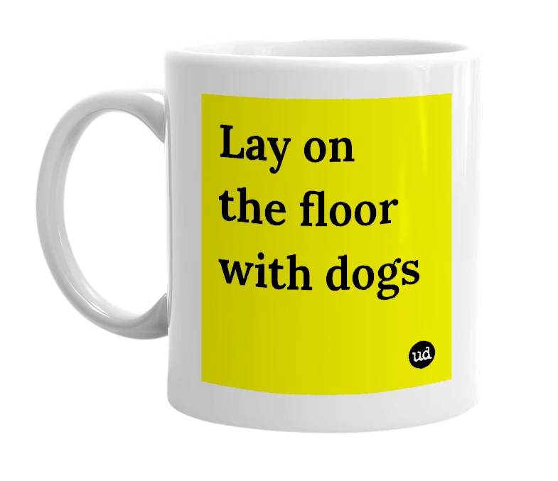 White mug with 'Lay on the floor with dogs' in bold black letters