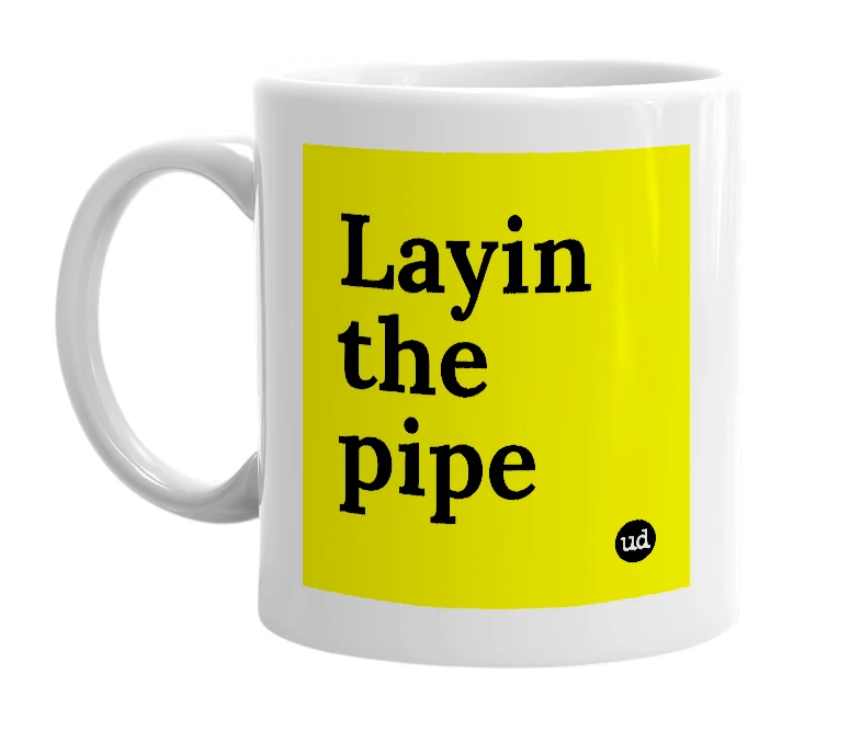White mug with 'Layin the pipe' in bold black letters