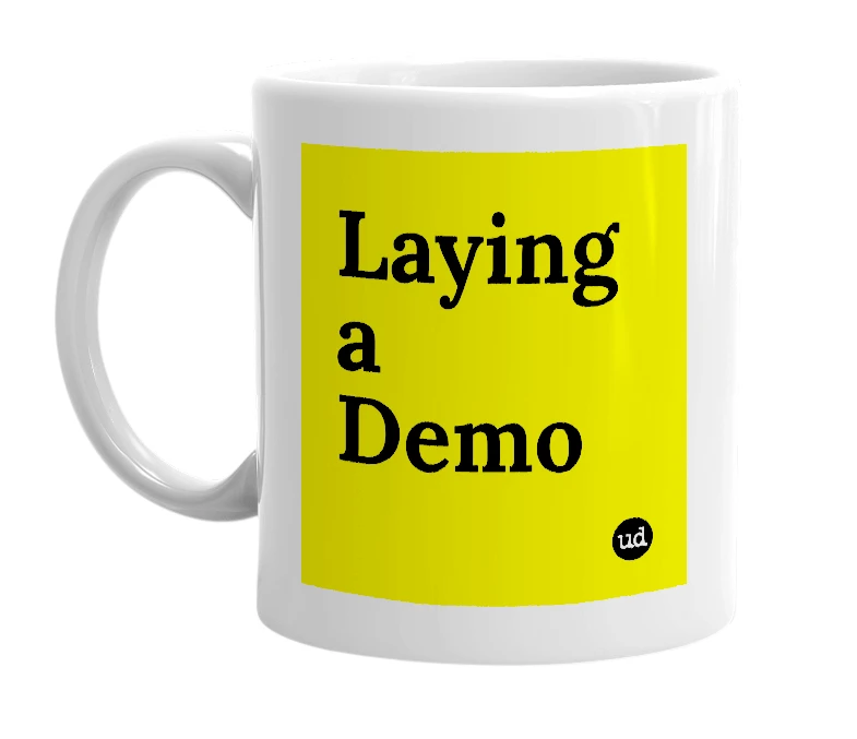 White mug with 'Laying a Demo' in bold black letters