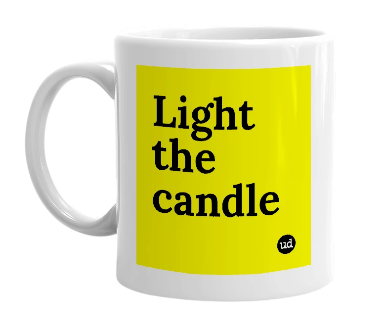 White mug with 'Light the candle' in bold black letters